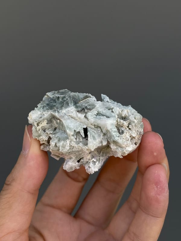 Pale metallic pyrite crystal on grey matrix from Shangbao, Hunan, China, detail of the matrix contact
