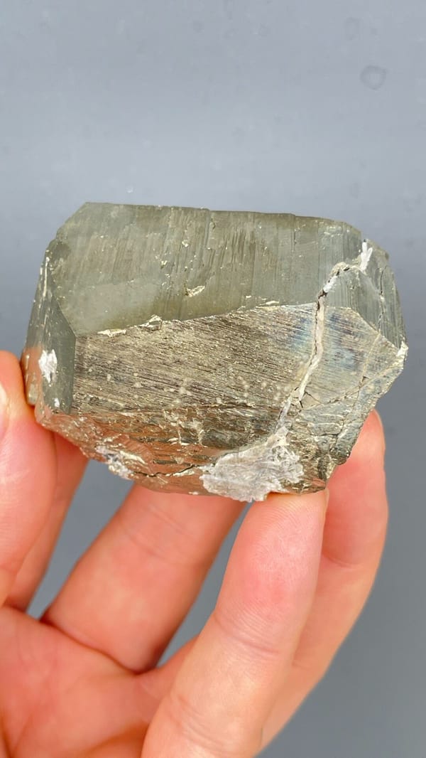 Large brassy striated pyrite single crystal from Yunnan, China, close-up of the crystal faces