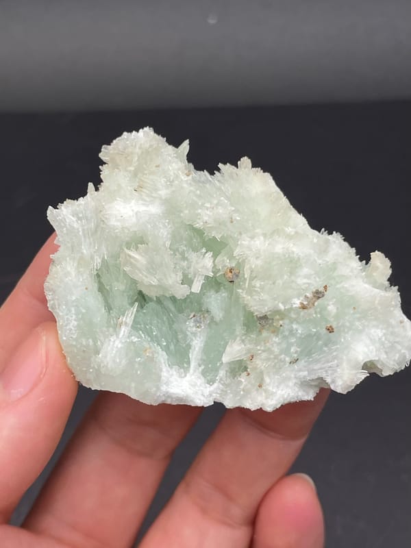 Pale blue-green bladed aragonite crust from Yunnan, China, close-up of the crystal faces
