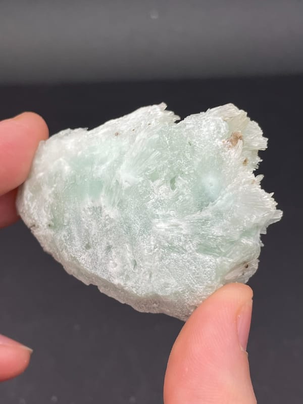 Pale blue-green bladed aragonite crust from Yunnan, China, detail of the matrix contact