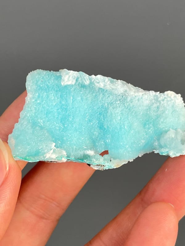 Turquoise-blue fibrous aragonite slab from Sichuan, China, close-up of the crystal faces