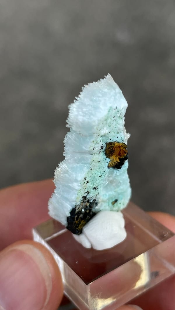 Sky-blue needle aragonite crust from Yunnan, China, on an acrylic stand, second angle