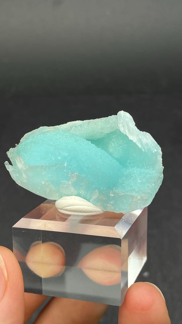 Turquoise-blue fibrous aragonite crust from Yunnan, China, on an acrylic stand, second angle