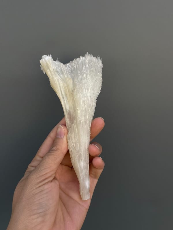 Long white fibrous aragonite fan from Guizhou, China, close-up of the crystal faces