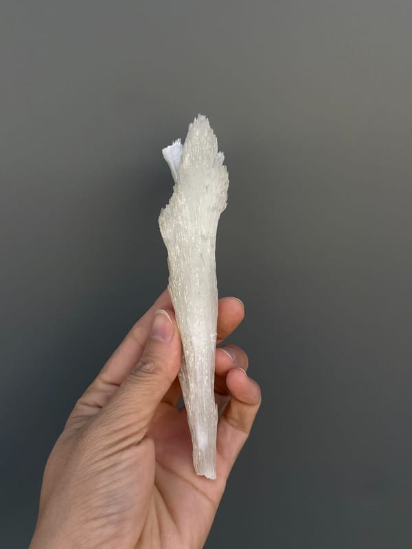 Long white fibrous aragonite fan from Guizhou, China, reverse side