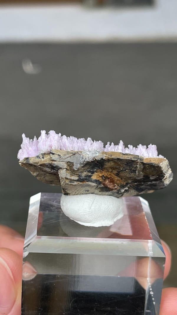 Pale pink aragonite sprays on tan matrix from Yunnan, China, detail of the matrix contact