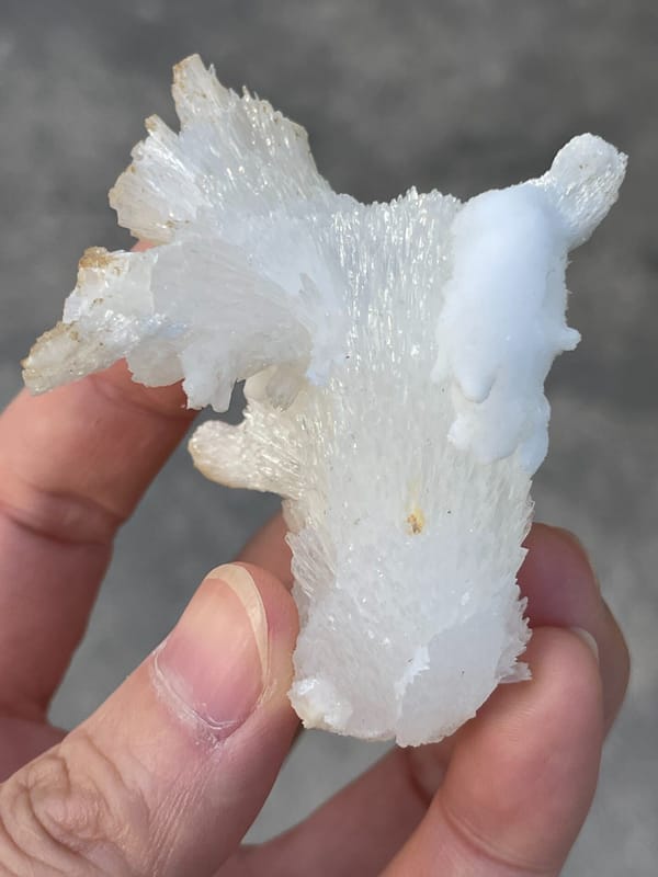 White fibrous aragonite spray from Guizhou, China, close-up of the crystal faces