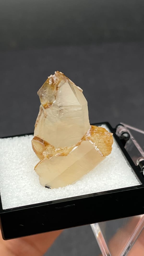 Caramel-brown frosted quartz crystal from Jinlong, Guangdong, China, in a box, close-up of the crystal faces
