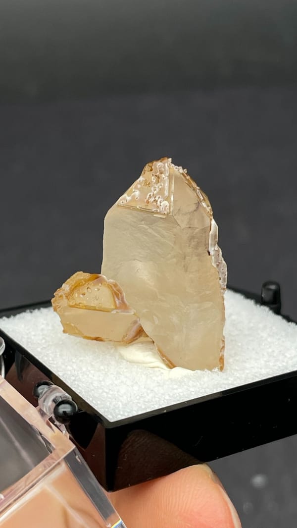 Caramel-brown frosted quartz crystal from Jinlong, Guangdong, China, in a box, top view