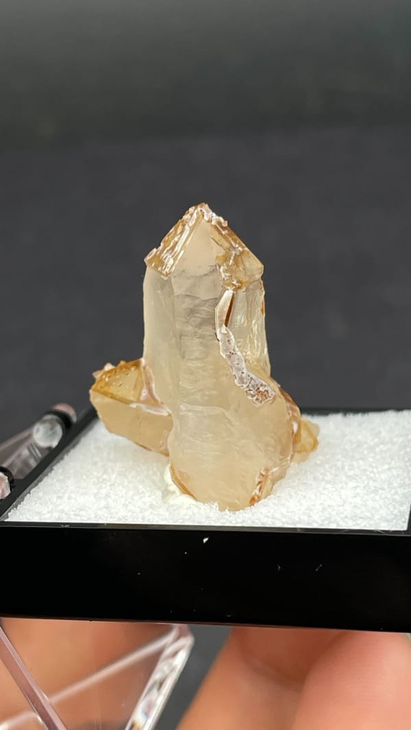 Caramel-brown frosted quartz crystal from Jinlong, Guangdong, China, in a box, detail of the matrix contact