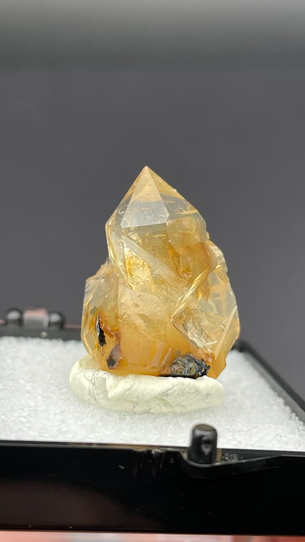 Caramel-brown transparent quartz crystal from Guangdong, China, in a display box, second angle