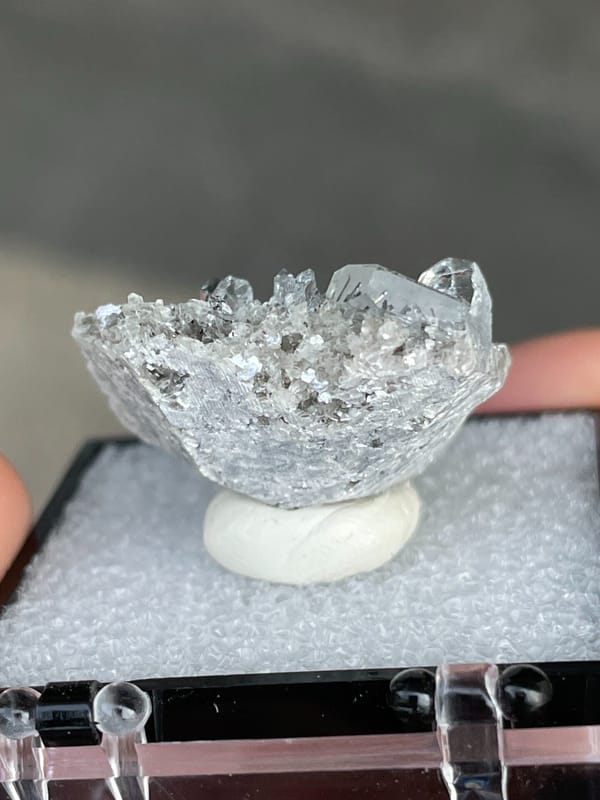 Pale blue aquamarine crystals on a dark mica bed, Xuebaoding, Sichuan, China, top view