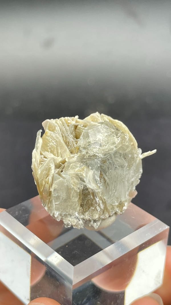Pale aquamarine among yellow-green mica books, Xuebaoding, Sichuan, China, close-up of the crystal faces