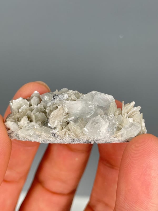 Pale aquamarine crystals in a white mica and quartz plate, Xuebaoding, Sichuan