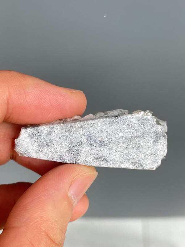 Pale aquamarine crystals in a white mica and quartz plate, Xuebaoding, Sichuan, detail of the matrix contact