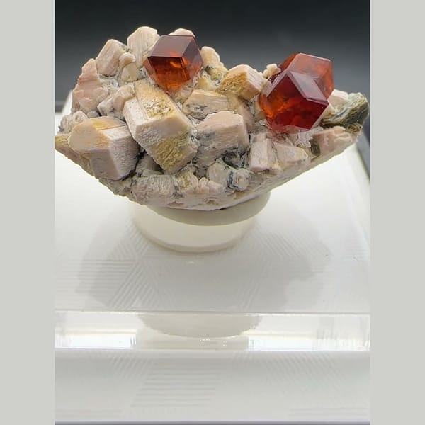 Orange-red spessartine garnet crystals on pale feldspar matrix from Yunxiao, Fujian, China — complete view