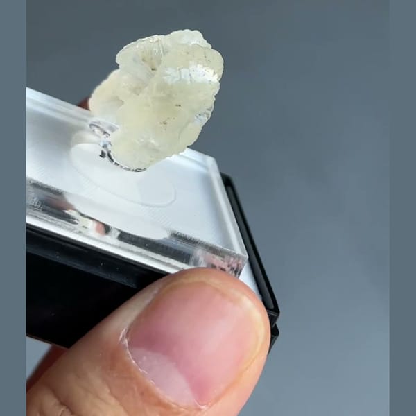 Translucent pale cream-green double bow-tie stilbite crystal from Nashik, Maharashtra, India — detail view