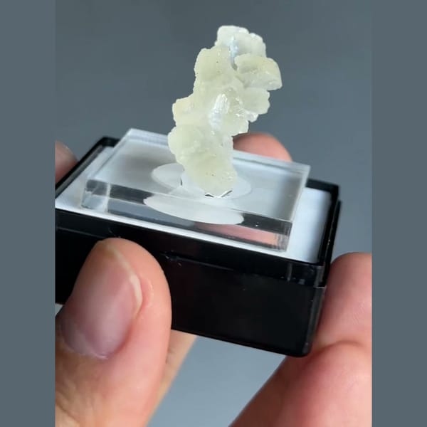 Translucent pale cream-green double bow-tie stilbite crystal from Nashik, Maharashtra, India — detail view