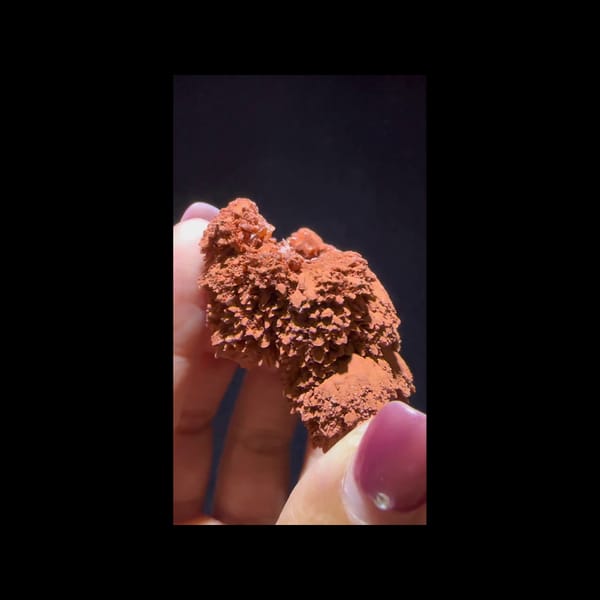 Red clay-coated calcite from Yunnan — complete front view