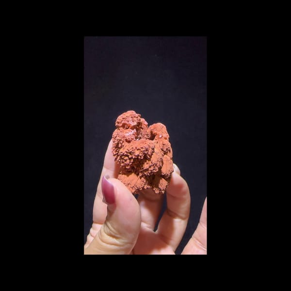 Red clay-coated calcite from Yunnan — alternate side view