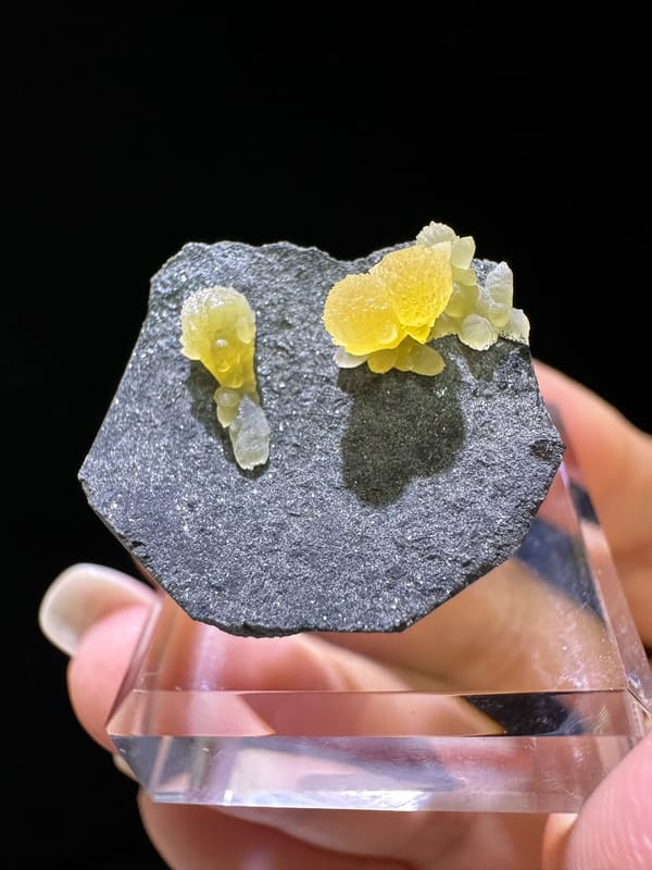 Yellow calcite cluster with pale extensions on dark matrix from Zhejiang China, specimen view 2