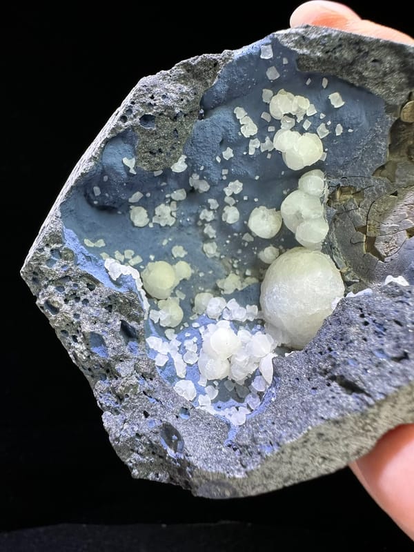 White calcite spheres lining a blue-gray cavity from Zhejiang China, specimen view 3