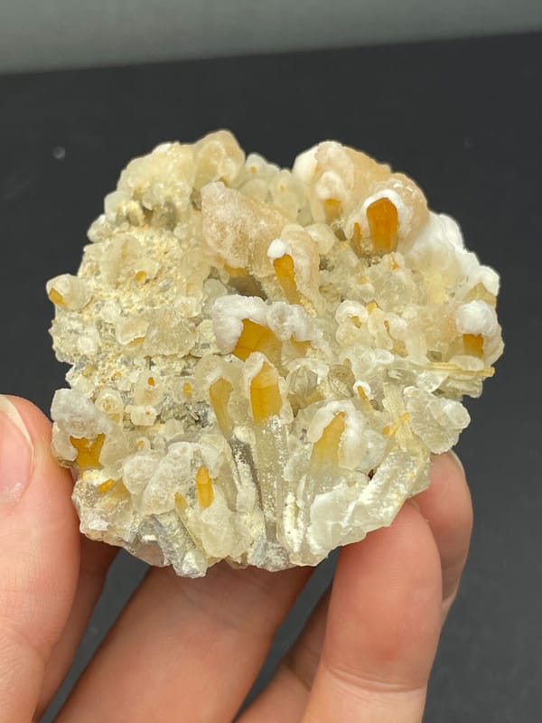 Cream-yellow citrine and calcite crust from Jinkouhe, Sichuan, China, close-up of the crystal faces