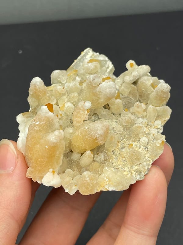 Cream-yellow citrine and calcite crust from Jinkouhe, Sichuan, China, top view
