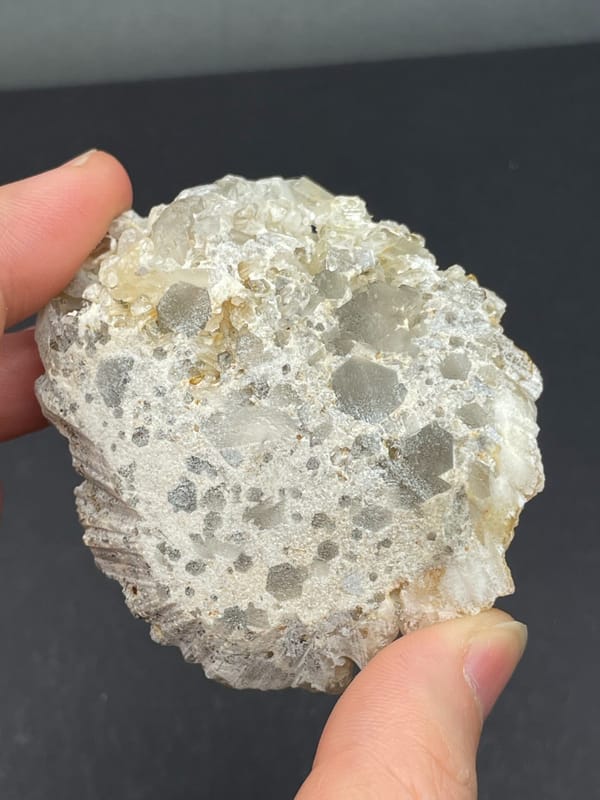 Cream-yellow citrine and calcite crust from Jinkouhe, Sichuan, China, detail of the matrix contact