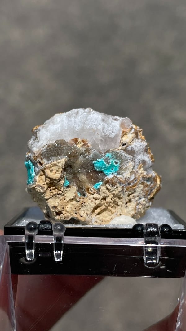 Turquoise copper-zinc carbonate crust on limonite from Yunnan, China, in a perky box, detail of the matrix contact