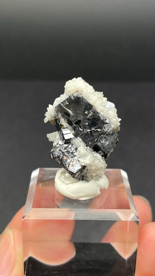 Metallic galena crystal in white dolomite crust from Jiangxi, China, detail of the matrix contact