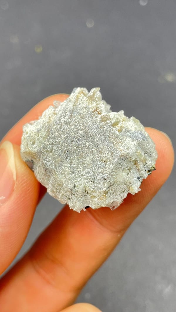 Metallic galena cubes with clear quartz points from Bulgaria, in a display box, detail of the matrix contact