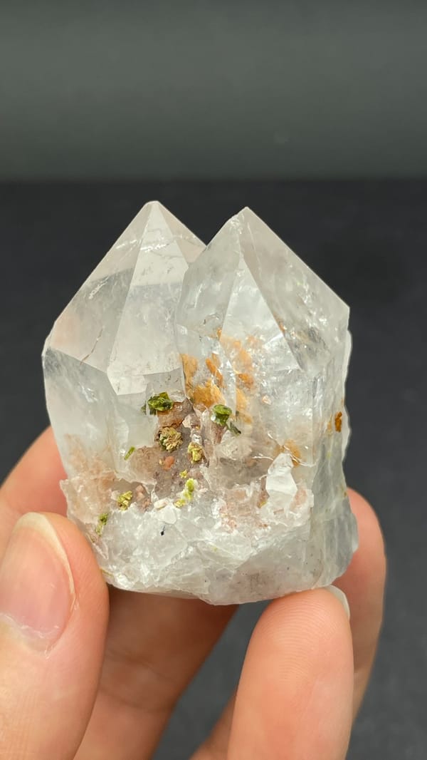 Garden quartz crystal with green epidote inclusions from Meigu, Sichuan, China, close-up of the crystal faces