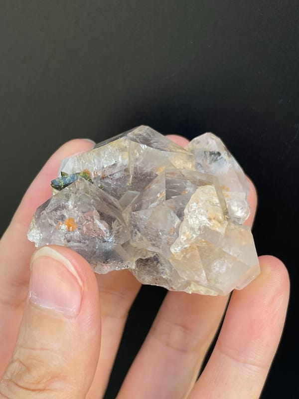 Clear garden quartz with green epidote inclusions from Meigu, Sichuan, China, detail of the matrix contact