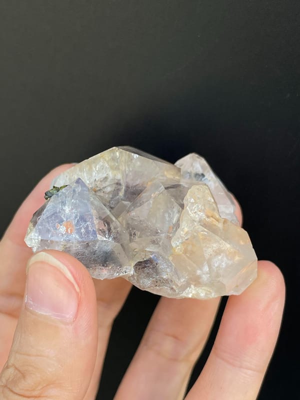 Clear garden quartz with green epidote inclusions from Meigu, Sichuan, China, side view