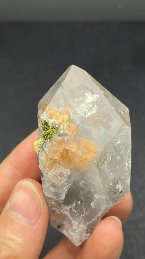 Large garden quartz crystal with epidote inclusions from Meigu, Sichuan, China, close-up of the crystal faces