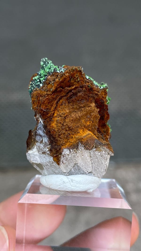 Grass-green conichalcite balls on quartz and matrix from Morocco, detail of the matrix contact