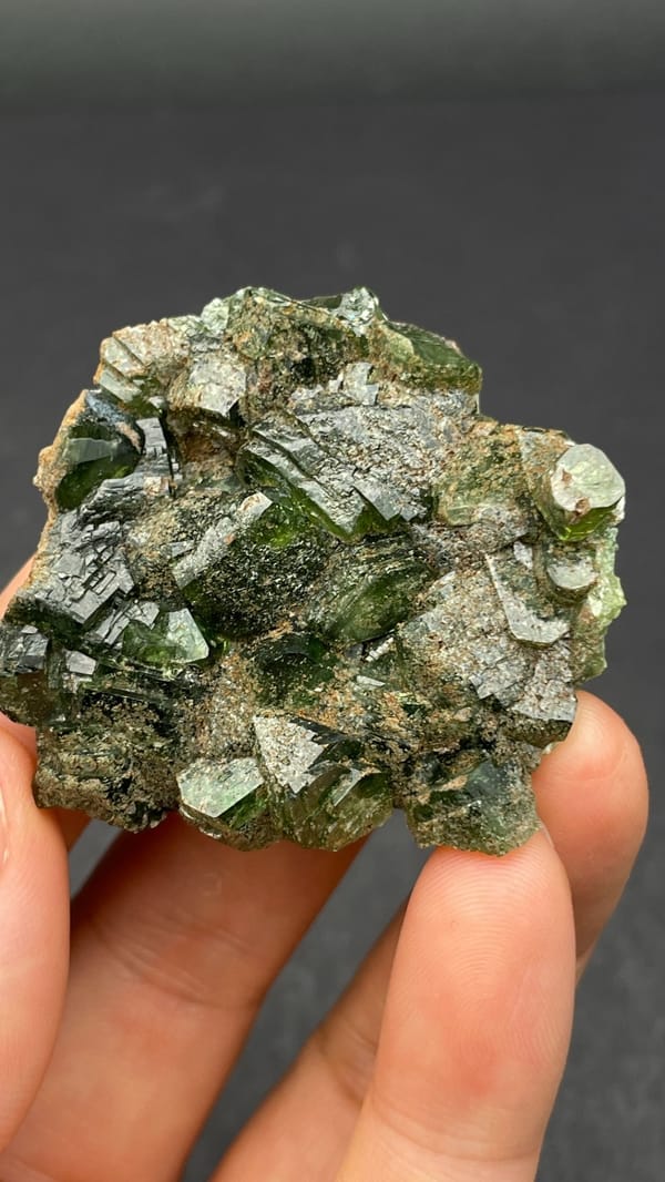 Apple-green ludlamite crystals on grey matrix from Brazil, reverse side