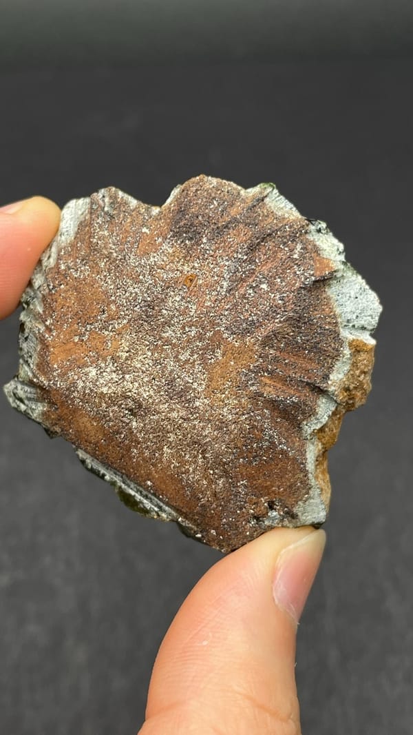 Apple-green ludlamite crystals on grey matrix from Brazil, detail of the matrix contact