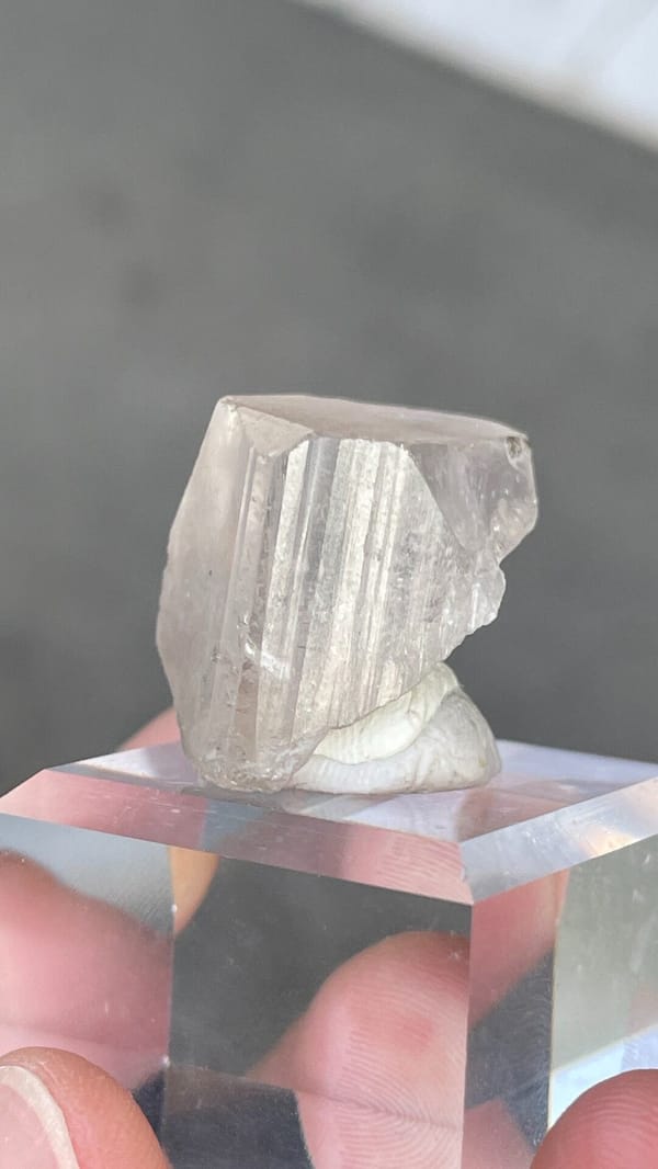 Colourless blocky topaz crystal from Yunnan, China, on an acrylic stand, top view