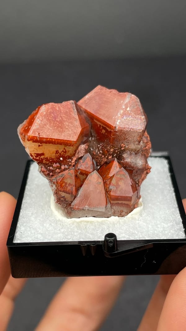 Deep red hematoid quartz crystals on matrix from Shanxi, China, in a perky box