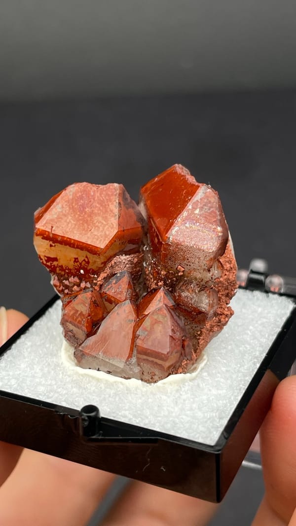 Deep red hematoid quartz crystals on matrix from Shanxi, China, in a perky box, reverse side