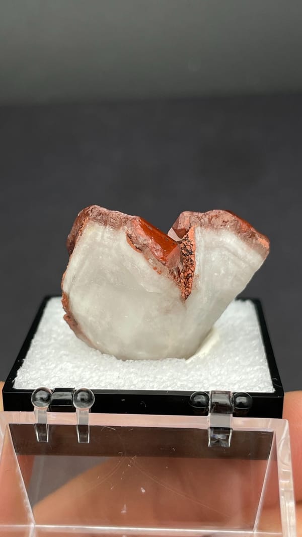 Deep red hematoid quartz crystals on matrix from Shanxi, China, in a perky box, detail of the matrix contact