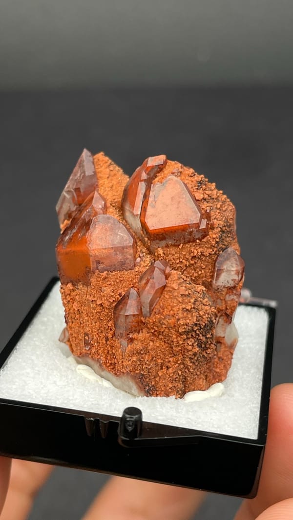 Red hematoid quartz with black specular hematite from Shanxi, China, in a perky box, second angle