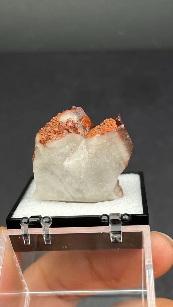 Red hematoid quartz with black specular hematite from Shanxi, China, in a perky box, top view