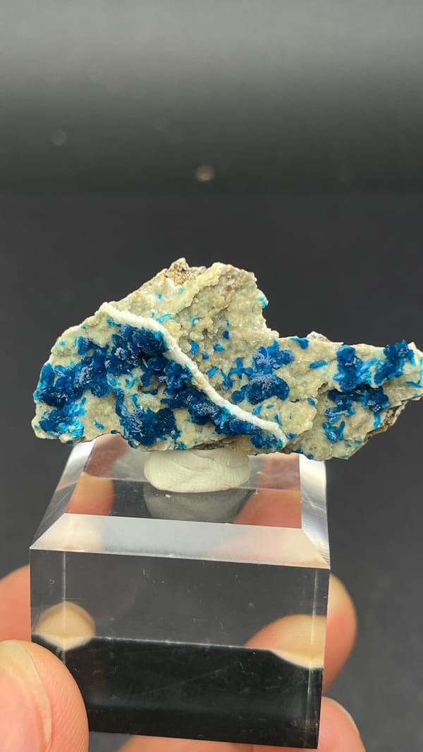 Deep blue veszelyite fan on cream matrix from Yunnan, China, on an acrylic stand, second angle