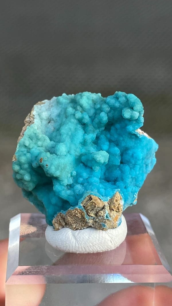 Turquoise botryoidal hemimorphite crust from Yunnan, China, on an acrylic stand