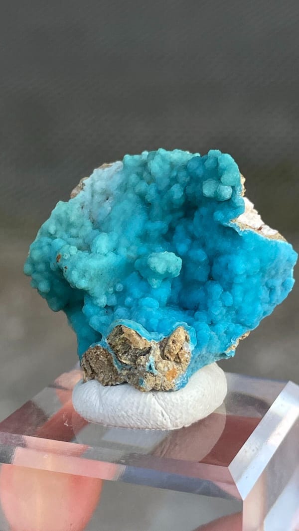 Turquoise botryoidal hemimorphite crust from Yunnan, China, on an acrylic stand, second angle