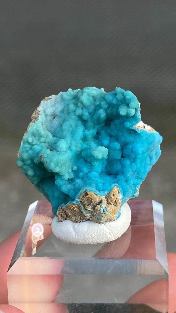 Turquoise botryoidal hemimorphite crust from Yunnan, China, on an acrylic stand, top view