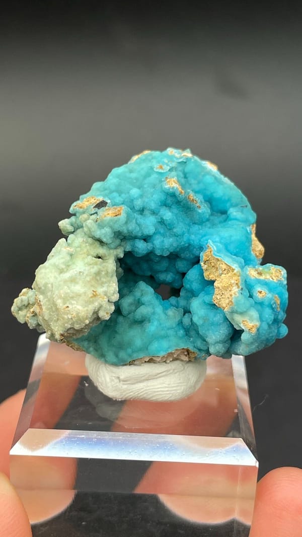 Turquoise botryoidal hemimorphite crust from Yunnan, China, on an acrylic stand, second angle